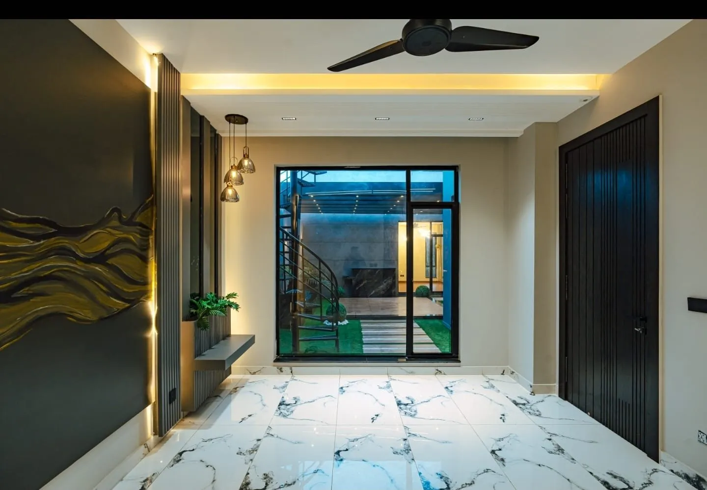 Room with decorative wall panels and a large window.