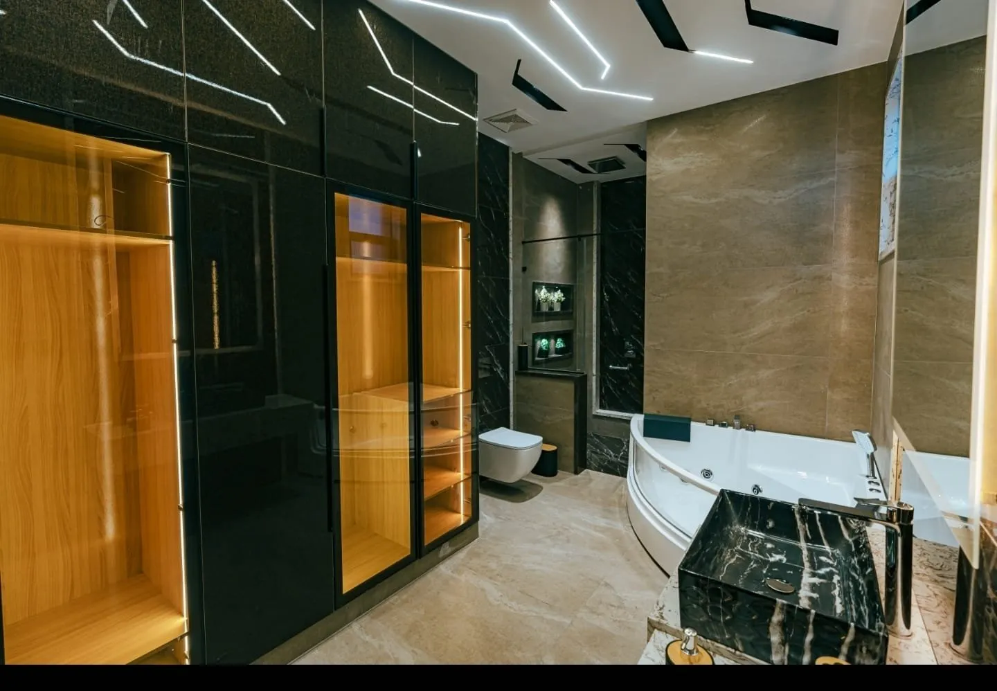 Bathroom with dark wall tiles and a vanity.