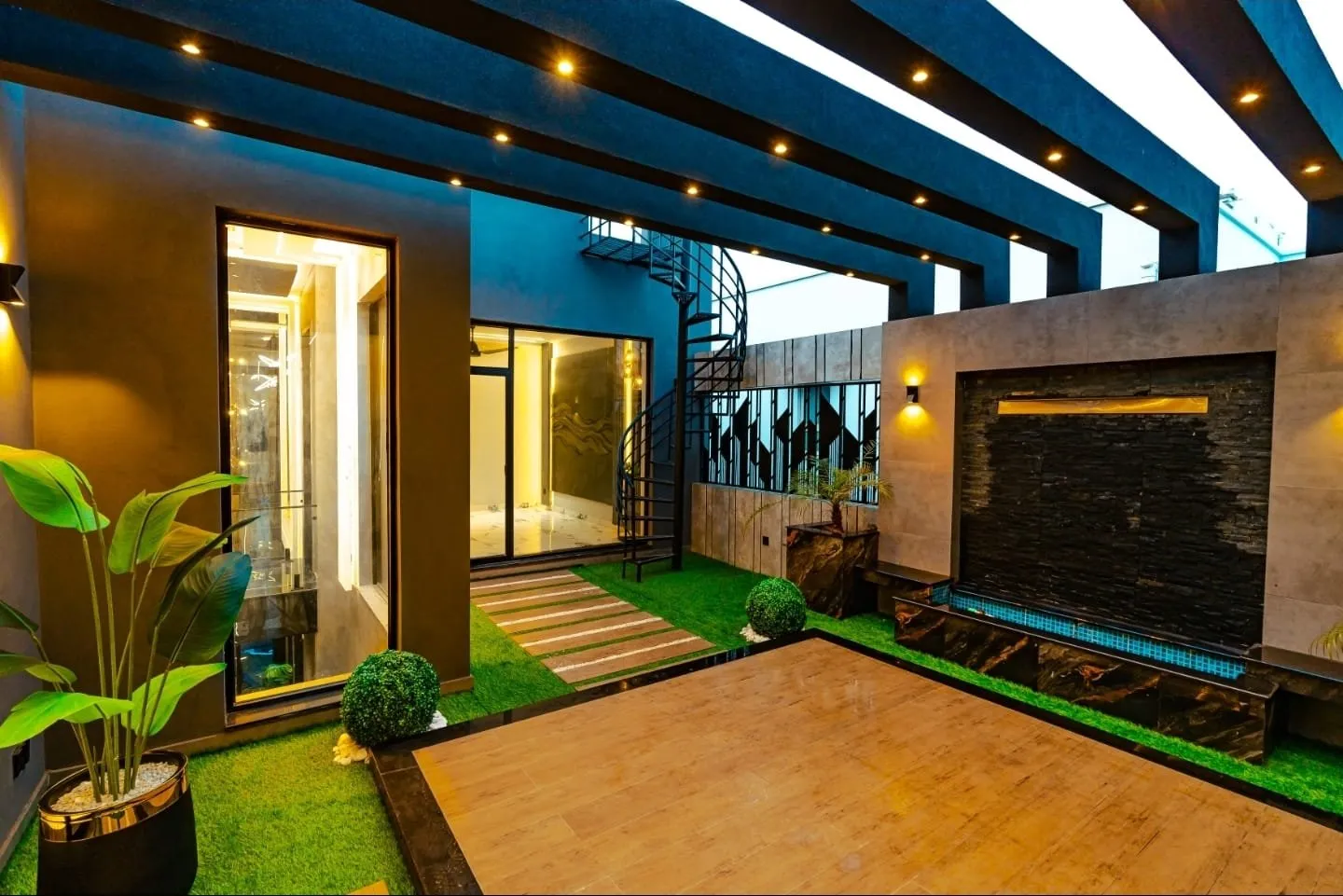 Outdoor area with overhead pergola beams and planting.