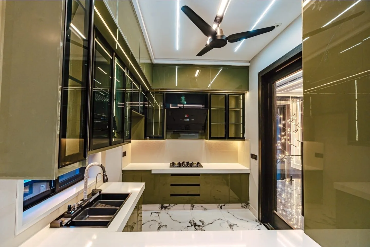 Kitchen with dark cabinets and corner windows.