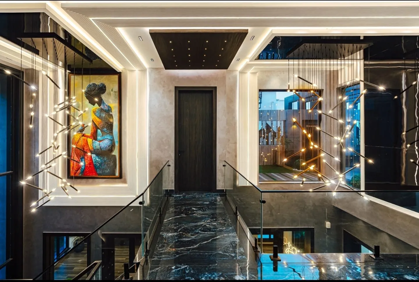 Landing with a glass railing and decorative pendant lights.