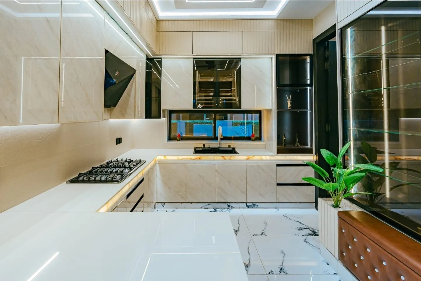 Kitchen with white cabinets and a large window.