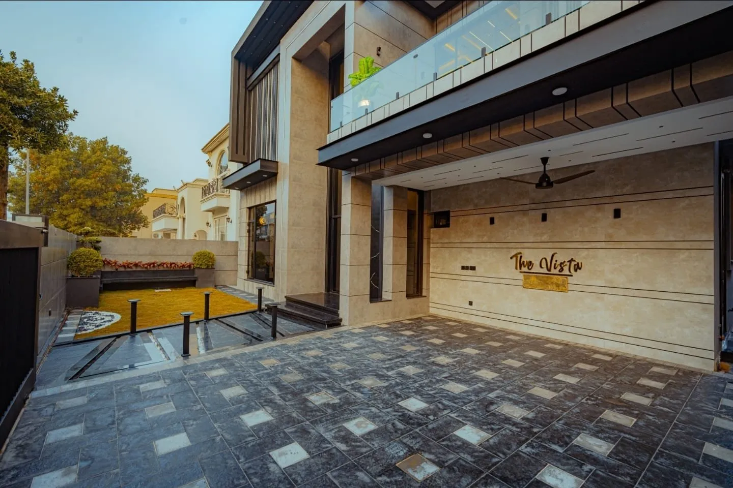 Covered entrance area with patterned paving.