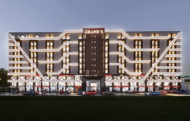 Front elevation of Grand X Bahria Town Lahore showing brand outlets and retail shops at night.
