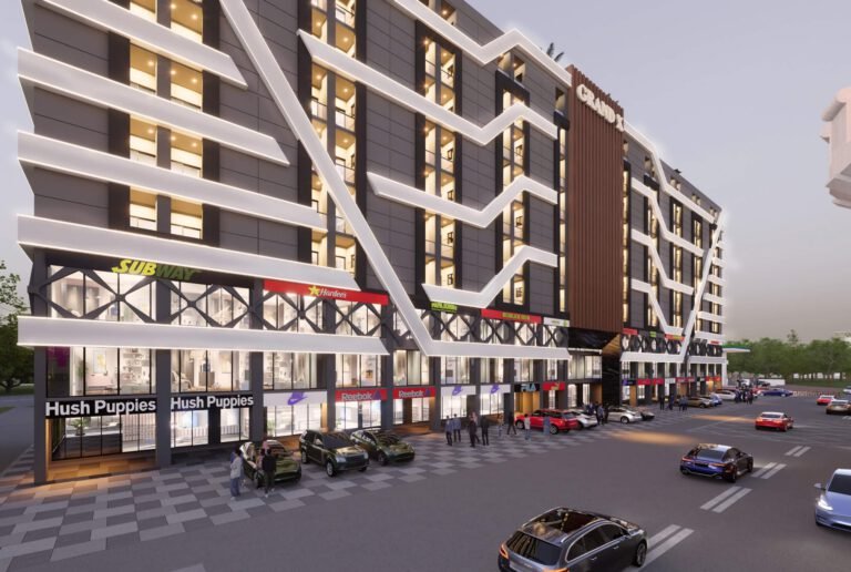 Perspective view of Grand X Shopping Mall entrance with international brand outlets and parking.